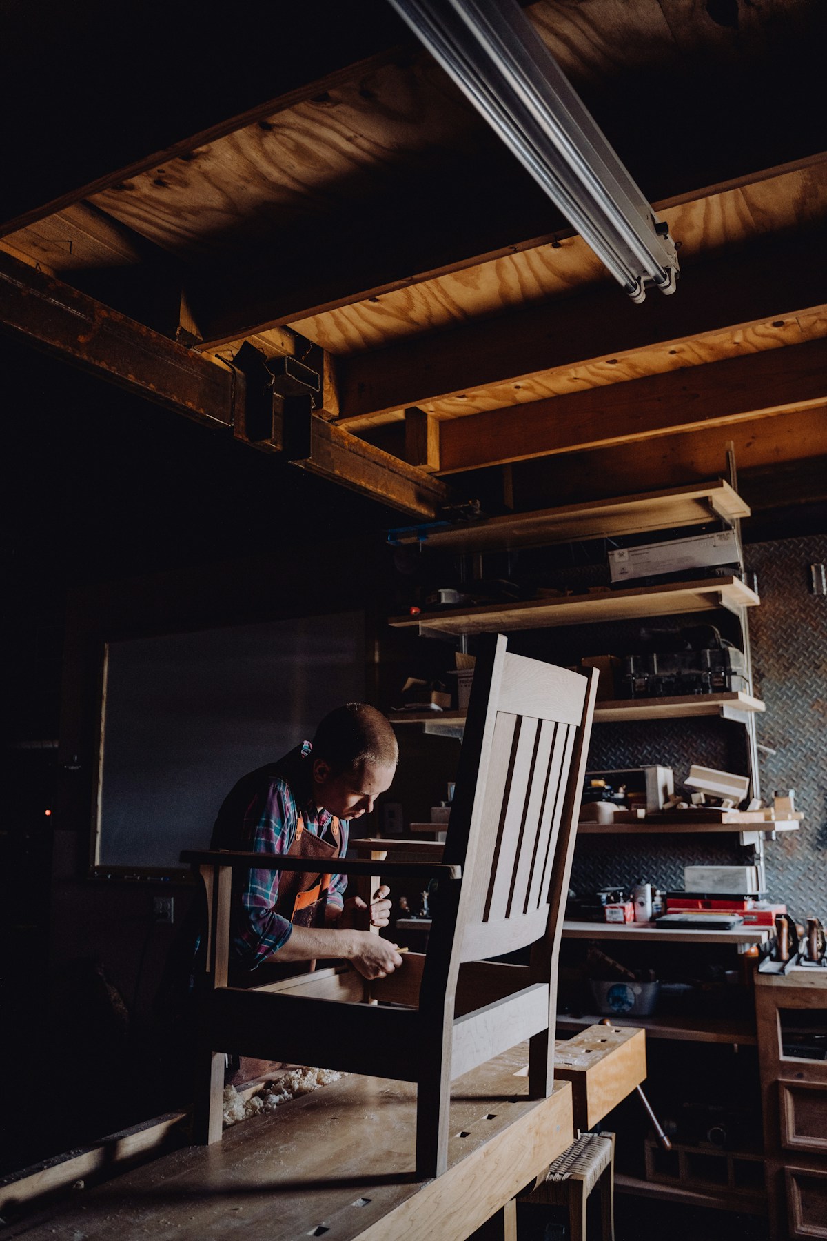 Carpenter sanding timber in the workshop