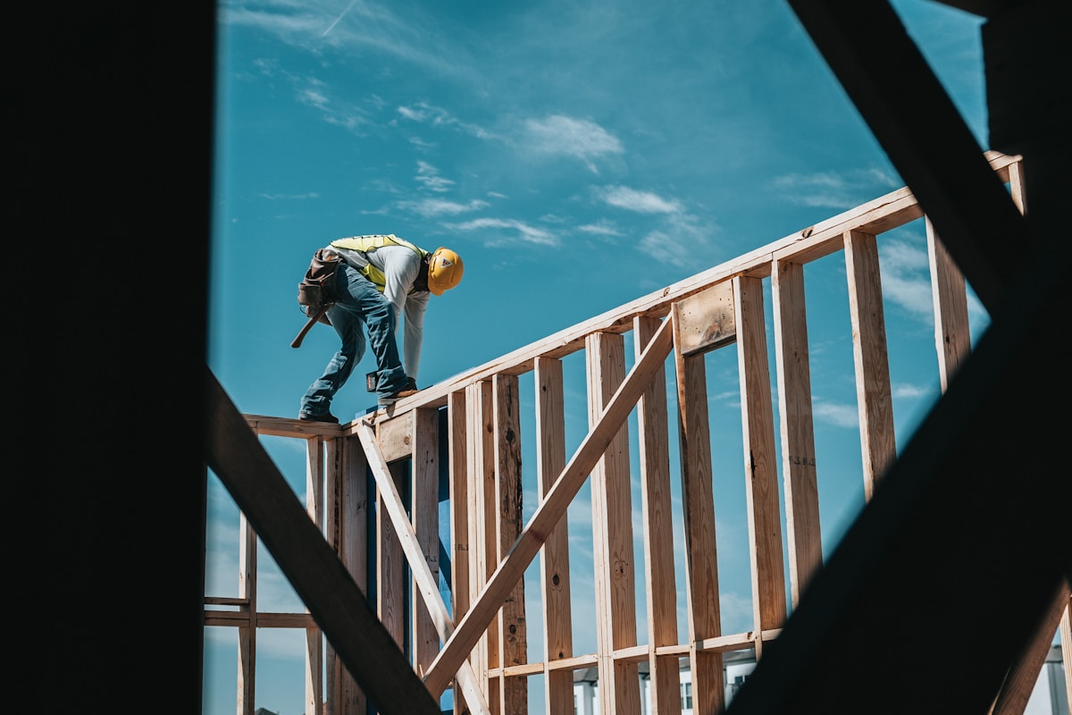 Carpenter framing a new house wall
